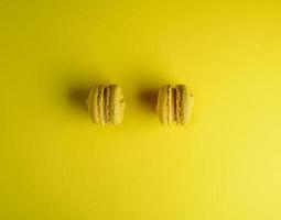 two yellow macarons on a yellow background photo