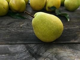 Green pear on a wooden shabby gray background photo