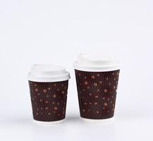 used brown paper cup with plastic cover for hot and cold drinks photo