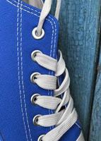 Detail of blue textile sneaker with white laces photo