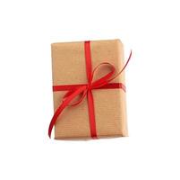 rectangular box wrapped in brown paper and tied with a red bow, photo