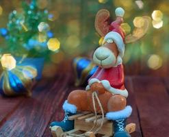 Reindeer on winter wooden sled, blurred bokeh background with multi-colored photo