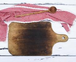 empty brown old kitchen cutting board and wooden spoon photo