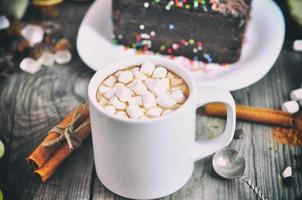 Cup with a drink and white marshmallow photo