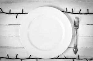 White empty plate with a fork photo