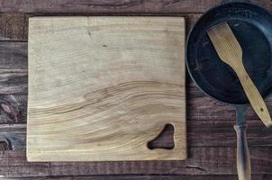 large wooden cutting board on brown surface photo