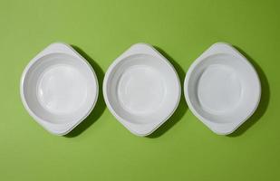 White empty plastic soup bowl on green background, top view photo