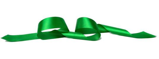 swirling green silk ribbon on white background, gift wrapping decor photo