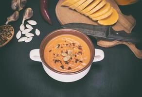 fresh pumpkin soup in a ceramic plate photo