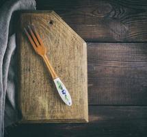 vintage wooden fork on a kitchen cutting board photo