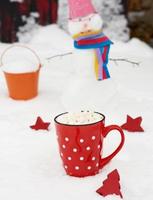 red ceramic mug with hot chocolate and marshmallow photo