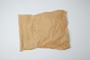 torn brown pieces of parchment paper on a white background photo