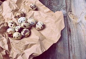 Raw quail eggs on brown kraft paper photo