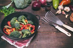 Fresh vegetables in a cast-iron black frying pan photo