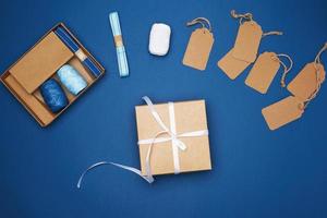 brown cardboard box tied with a white ribbon and a set for packing holiday gifts photo