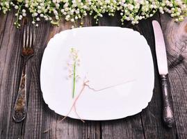 white square plate with iron cutlery photo