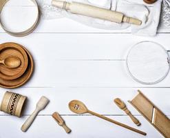 wooden round plates, sieve and rolling pin, round cutting board and other kitchen items photo