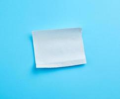 torn soft white sheet of paper towel with curled corners photo