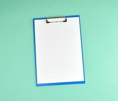 blue holder with clean white sheets on a green background photo