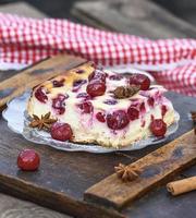 piece of cottage cheese pie and canned cherries photo