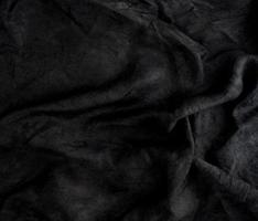 fragment of black cotton fabric with waves photo