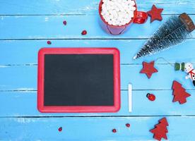 black chalkboard in a red frame on a blue wooden background photo