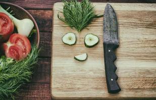 tomato and funny face of cucumber slices photo