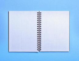 open blank notebook in a box on a blue background photo