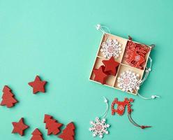 wooden carved Christmas decorations for the holiday tree on a green background photo