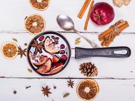 mulled wine with spices and fruits in an aluminum container photo