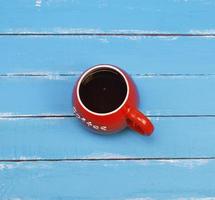 Black coffee in a red ceramic mug photo