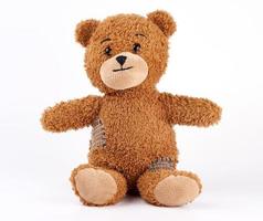 brown vintage teddy bear with patches photo