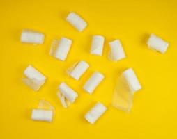 rolled up white sterile medical bandages on a yellow background photo