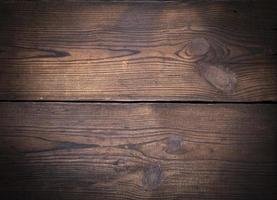 brown wooden background of old boards with swirls photo