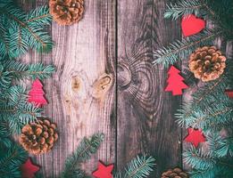 gray wood background with green spruce branches and Christmas decor photo