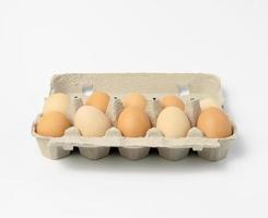 fresh whole brown eggs in paper packaging photo
