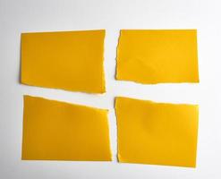 empty torn pieces of yellow paper on a white background photo