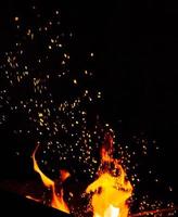 burning fire with a rising column of orange and yellow sparks photo