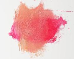 sample of red smeared lipstick on white background photo