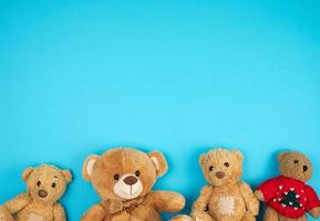 four teddy bears on a blue background, friendship concept photo