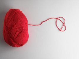 big skein of red wool on a white background, top view photo