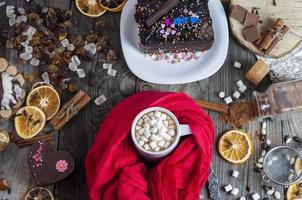 Hot chocolate with white marshmallow on a gray wooden surface photo