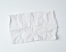 crumpled torn soft white sheet of paper towel with curled corners photo