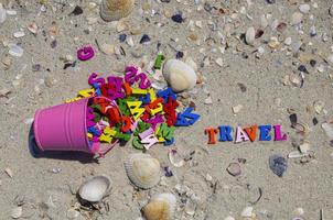 Multicolored wooden letters in a pink iron bucket photo