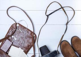 open brown leather bag, boots and vintage camera photo