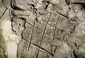 a fragment of a gray cement wall with a non-level surface photo