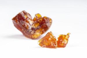 amber stones of concentrated thc extract resin isolated on white background photo