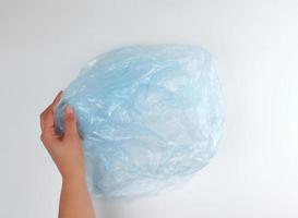 blue plastic garbage bag in female hand photo