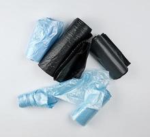 black and blue plastic bags for trash can on a white background photo