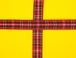 red decorative ribbon in a box cross on a cross photo